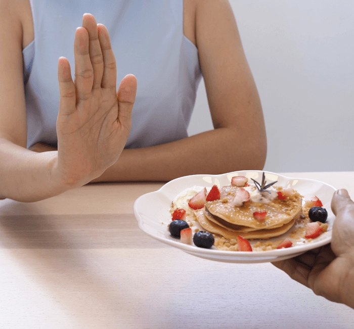 Person turning down a plate of food